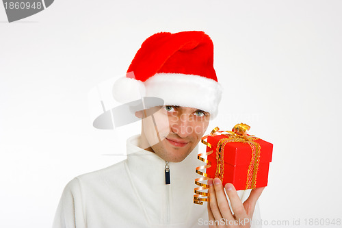 Image of young man in a Santa hat holding gift