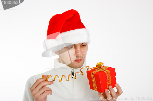 Image of young man in a Santa hat holding gift