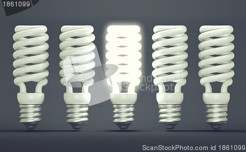 Image of Idea or invention: illuminated efficient bulb among group of off