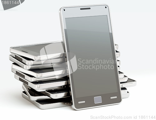 Image of Stack of cellphones with touch screens over white