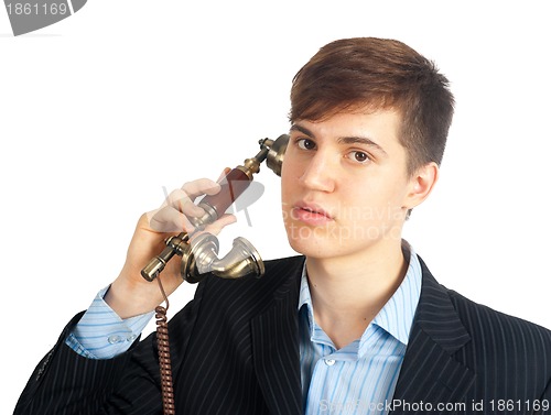 Image of young man talking on retro phone