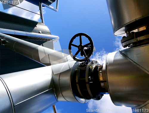 Image of Industrial zone, Steel pipelines and valves against blue sky