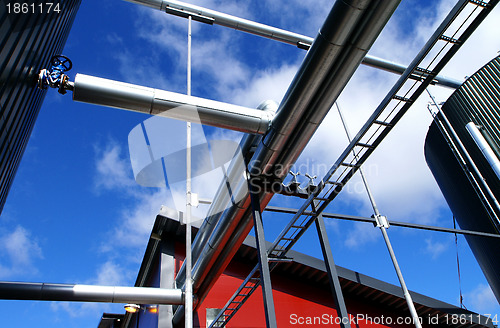 Image of Industrial zone, Steel pipelines and valves against blue sky