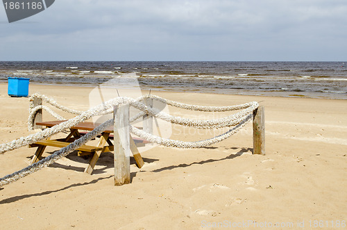 Image of Rope log fence beach sand table bench waste bin 