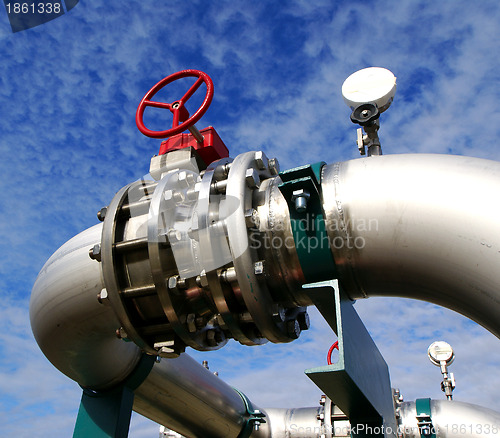 Image of Industrial zone, Steel pipelines and valves against blue sky