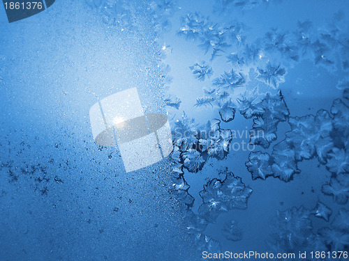 Image of Ice pattern and sunlight on winter glass