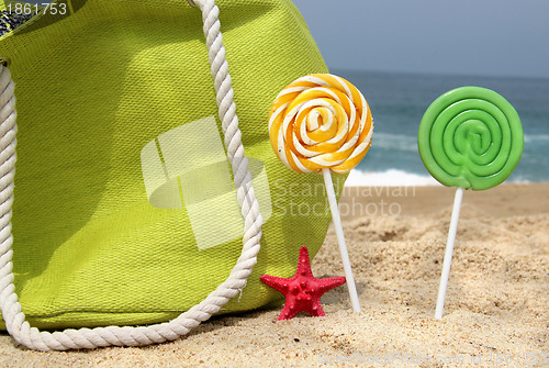 Image of Green beach bag, two candles and funny sea star