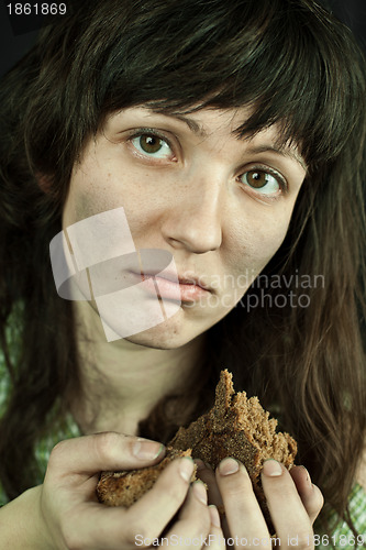 Image of beggar woman with a piece of bread 