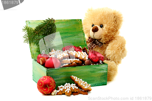 Image of Christmas toys and gingerbread in a box.