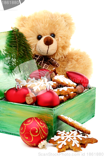 Image of Christmas box with toys and cookies.