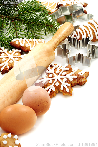 Image of Christmas ginger biscuits, eggs, rolling pin and dough forms.