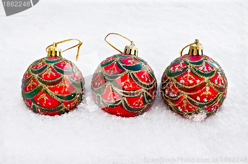 Image of Christmas red balls in the snow
