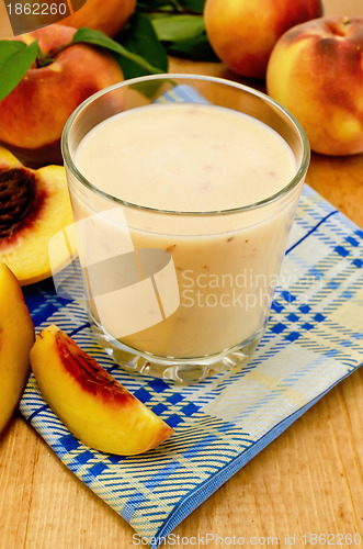 Image of Milk cocktail with peach on the napkin