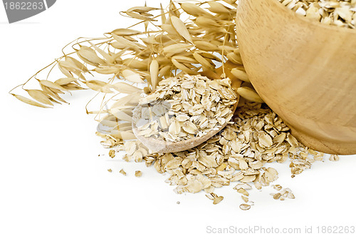Image of Oat flakes in a bowl and spoon