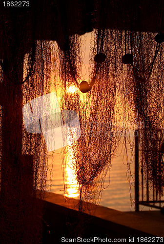 Image of Wonderful sea sunset with palm tree silhouettes and fishing nets