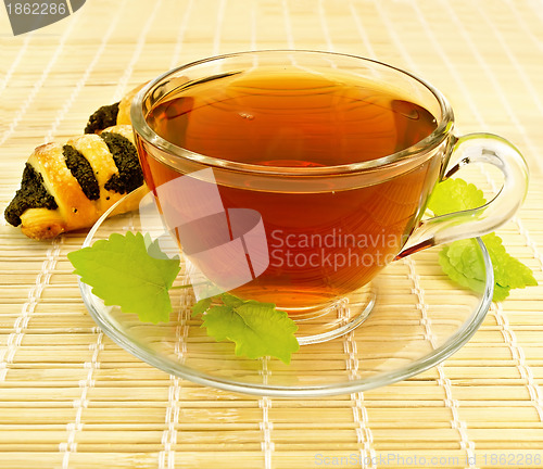 Image of Tea with mint and cookies on a bamboo napkin