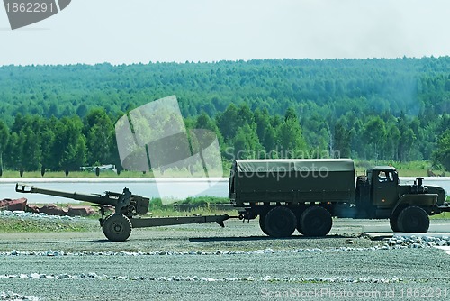Image of army truck transports a gun