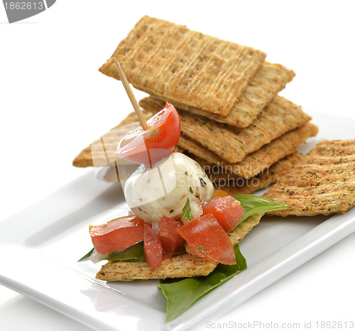 Image of Crackers With Mozzarella And Tomatoes