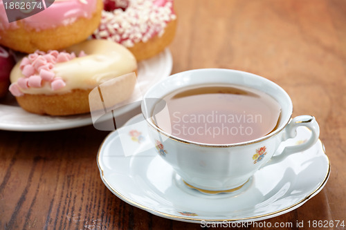 Image of tea cup and doughnuts