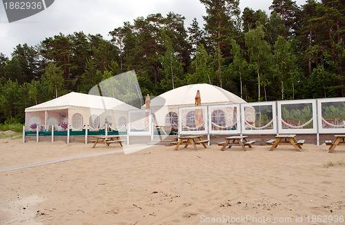 Image of Restaurant bar tents on seaside sand 