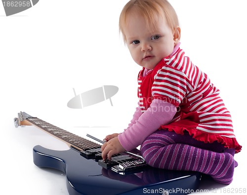 Image of Little girl playing with guitar