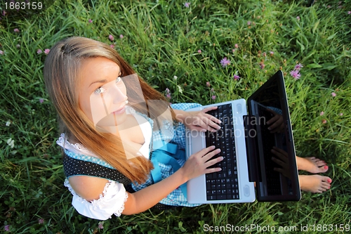 Image of Bavarina Woman in Flowering Meadow with Laptop from above