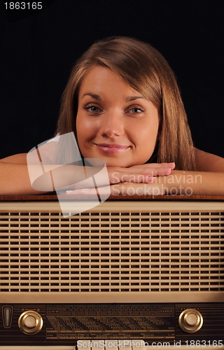 Image of Woman leaning on antique radio