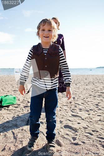 Image of Young boy at beach with mother.