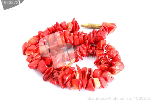 Image of red beads over white