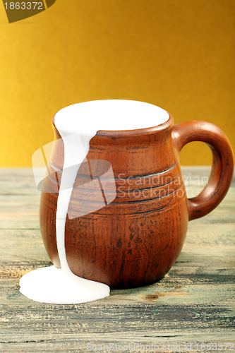 Image of Ceramic mug with cream.