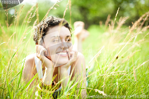 Image of cute girl on green field 