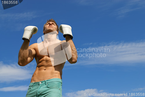 Image of Strong man in boxing gloves. The winner.