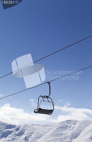 Image of Chair lift against blue sky
