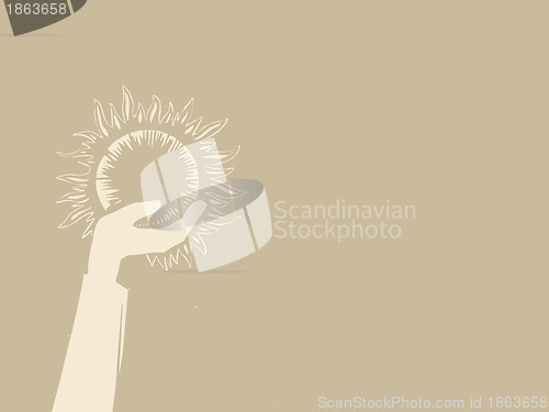 Image of sun in hand on brown background