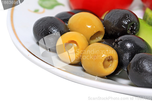 Image of olives in a blue plate on a white background