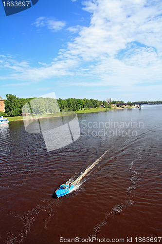 Image of boat sails on broad river