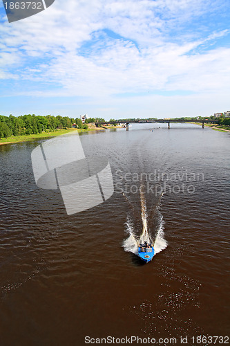 Image of boat sails on broad river