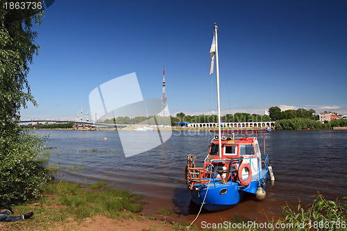 Image of old motorboat on river coast