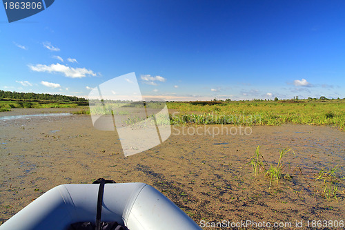 Image of rubber boat on green marsh