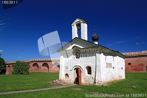 Image of aging blanching church amongst green herb