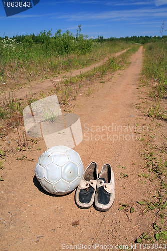 Image of shabby shoe on rural road