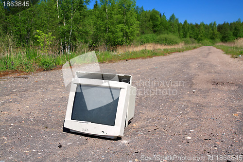 Image of brokenned computer on old road