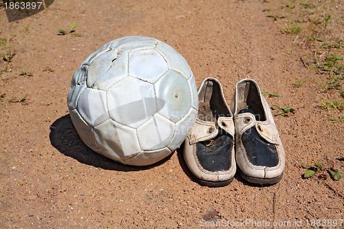 Image of shabby shoe on rural road