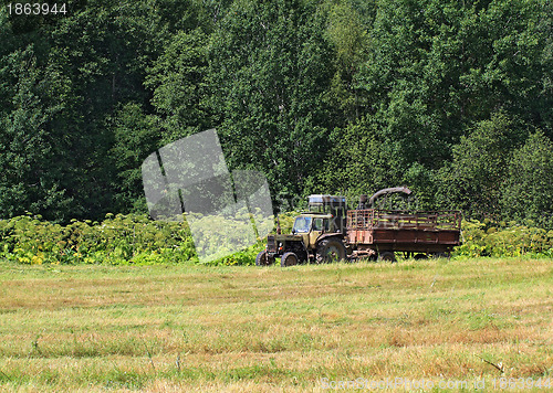 Image of old tractor on summer field