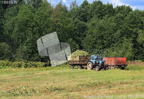 Image of old tractor on summer field