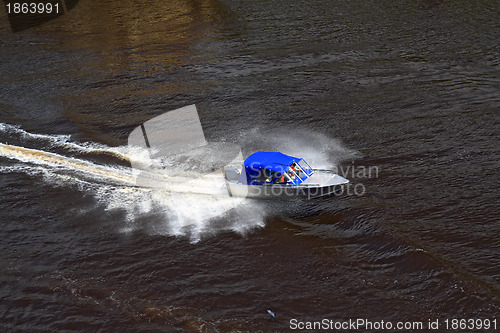 Image of boat sails on broad river