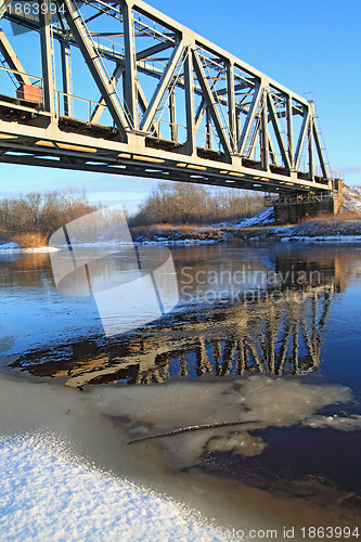 Image of railway bridge through small river 