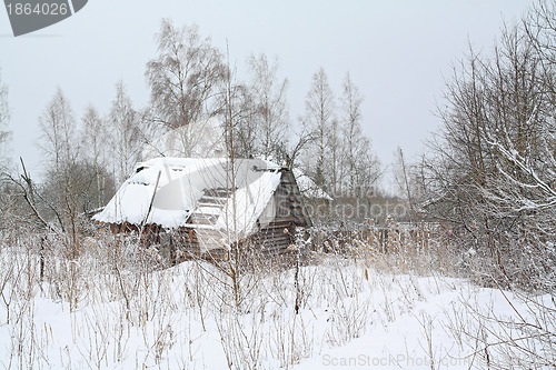 Image of old rural house amongst white snow