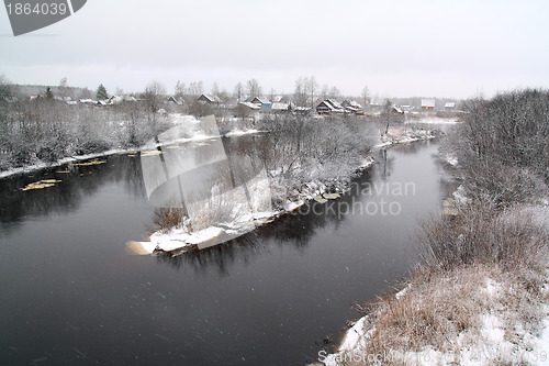 Image of snow village on coast river 