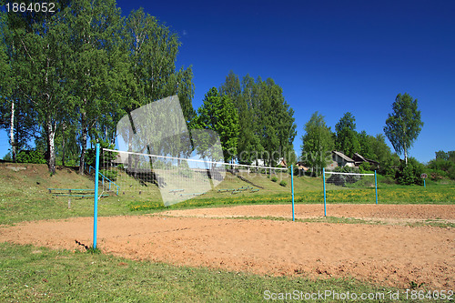 Image of volleyball net amongst summer tree